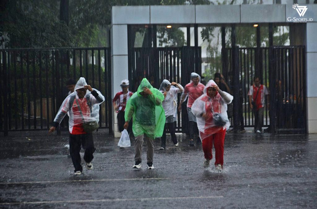 Hujan lebat yang mengguyur Jakarta, tidak menyurutkan langkah fans untuk menyaksikan pembukaan Piala Presiden 2025 di SUGBK, Minggu (6/7/2025). (Foto: Irfan Sudrajat/Grafis: Menk Karmawan/G-Sports.id).